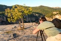 SIURANA DE PRADES, SPAIN - OCTOBER 5, 2017: A photographer with a tripod takes pictures of the landscape. Copy space for text.