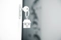 Siver house keyring on white door Royalty Free Stock Photo