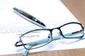 Siver Pen on the contract papers, glasses Royalty Free Stock Photo