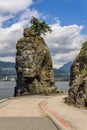 Siwash Rock Stanley Park Seawall in sunny day with white clouds over North Vancouver British Columbia Canada Royalty Free Stock Photo