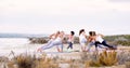 Women practising yoga do Side Angle Pose or Parivrtta Parsvakonasana outdoors