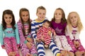 Six beautiful children wearing their winter pajamas sitting