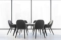 Six black chairs with white kitchen table near a big window with view of the city Royalty Free Stock Photo