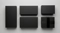 Six black, rectangular boxes are arranged on a plain light gray surface. The boxes vary in size, Royalty Free Stock Photo