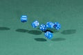 Six blue dices falling on a green table Royalty Free Stock Photo