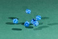 Six blue dices falling on a green table Royalty Free Stock Photo
