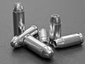 Six bullets, three 40 caliber hollow point and three 44spl on a gray background Royalty Free Stock Photo