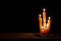 Six burning candles against a black background. Royalty Free Stock Photo