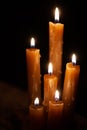 Six burning candles against a black background. Royalty Free Stock Photo
