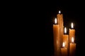 Six burning candles against a black background. Royalty Free Stock Photo