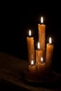 Six burning candles against a black background. Royalty Free Stock Photo