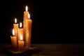 Six burning candles against a black background. Royalty Free Stock Photo