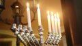 six burning candles with burning flame in beautiful Hanukah menora indoors. Jewish holidays celebration