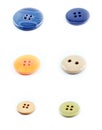 Six buttons in different colors and shapes and sizes. Blue, yellow, white, beige and green buttons. Isolated against a Royalty Free Stock Photo