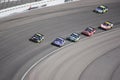 Six cars in Turn 4 of a NASCAR race in Las Vegas