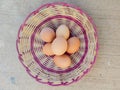 six chicken eggs on rattan wicker Royalty Free Stock Photo