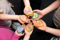 Six children`s hands hold handmade soap in the form of a heart against a dark background Royalty Free Stock Photo