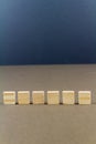 Six children wooden blocks in line, portrait