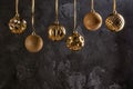 Six Christmas balls of golden color are hanging by a ribbon. Festive composition with copy space. Layout with place for Royalty Free Stock Photo