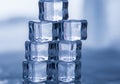 Six clear ice cubes are stacked in the shape of a pyramid on a Royalty Free Stock Photo