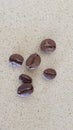 Six coffie beans on a marble surface Royalty Free Stock Photo