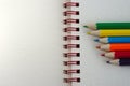 Six colored pencils on a white paper Royalty Free Stock Photo