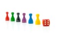 Six colorful pawns with red dice