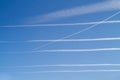 Six condensation trails in a blue sky