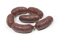 Six crude black pudding sausages on a white background Royalty Free Stock Photo