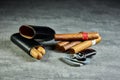 Six Cuban cigars on a stone table with a lighter, cutter and a leather case Royalty Free Stock Photo