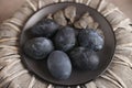 Six dark colored eggs on a plate Royalty Free Stock Photo