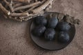 Six dark colored eggs on a plate Royalty Free Stock Photo