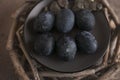 Six dark colored eggs on a plate Royalty Free Stock Photo