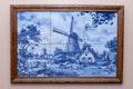 Six Delft Blue tiles in a frame, a souvenir from Holland/Netherlands. hanging on a wall making a windmill and typical farm scene Royalty Free Stock Photo