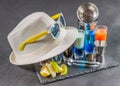 six different colored shot drinks, lined up on a black stone plate, ice cubes in shaker and ice tongs, lemon and lime, white Royalty Free Stock Photo