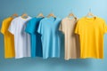 six different colored t - shirts hanging on hangers Royalty Free Stock Photo