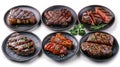 Six different types of grilled steak on black plates Royalty Free Stock Photo