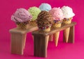 Six Flavors of Ice Cream in Sugar Cones on a Bright Pink Background Royalty Free Stock Photo