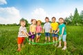 Six funny children holding one hoop together