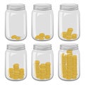 Six glass jars with different number of coins inside on a white