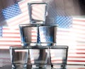 Six glasses stacked by a tower on a multi-colored background Royalty Free Stock Photo