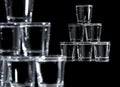 Six glasses stacked by a tower on a multi-colored background Royalty Free Stock Photo
