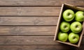 Six Green Apples in a Brown Box on Rustic Wooden Surface Royalty Free Stock Photo