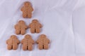 Six Happy Gingerbread Men in triangle formation isolated on white. Christmas baking concept