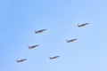 six mirage fighter jets accelerating and climbing into a clear, blue sky