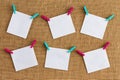 Six misaligned blank white notepads on hessian Royalty Free Stock Photo