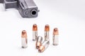 Six 9mm hollow point bullets in front of a black 9mm pistol Royalty Free Stock Photo