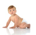 Six month infant child baby toddler sitting in diaper looking at Royalty Free Stock Photo