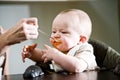 Six month old baby eating solid food Royalty Free Stock Photo