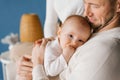 Six-month-old baby son in the arms of his happy father Royalty Free Stock Photo